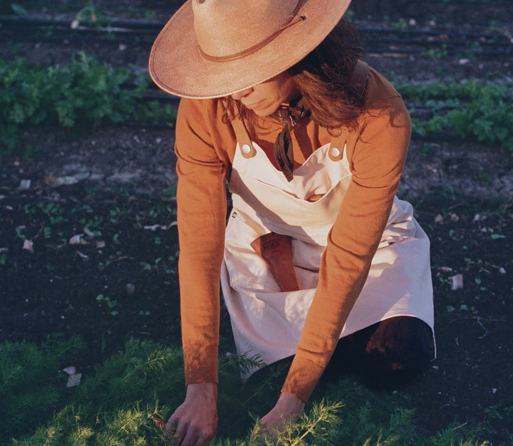 Woman gardening in Savilino Farm to Kitchen apron