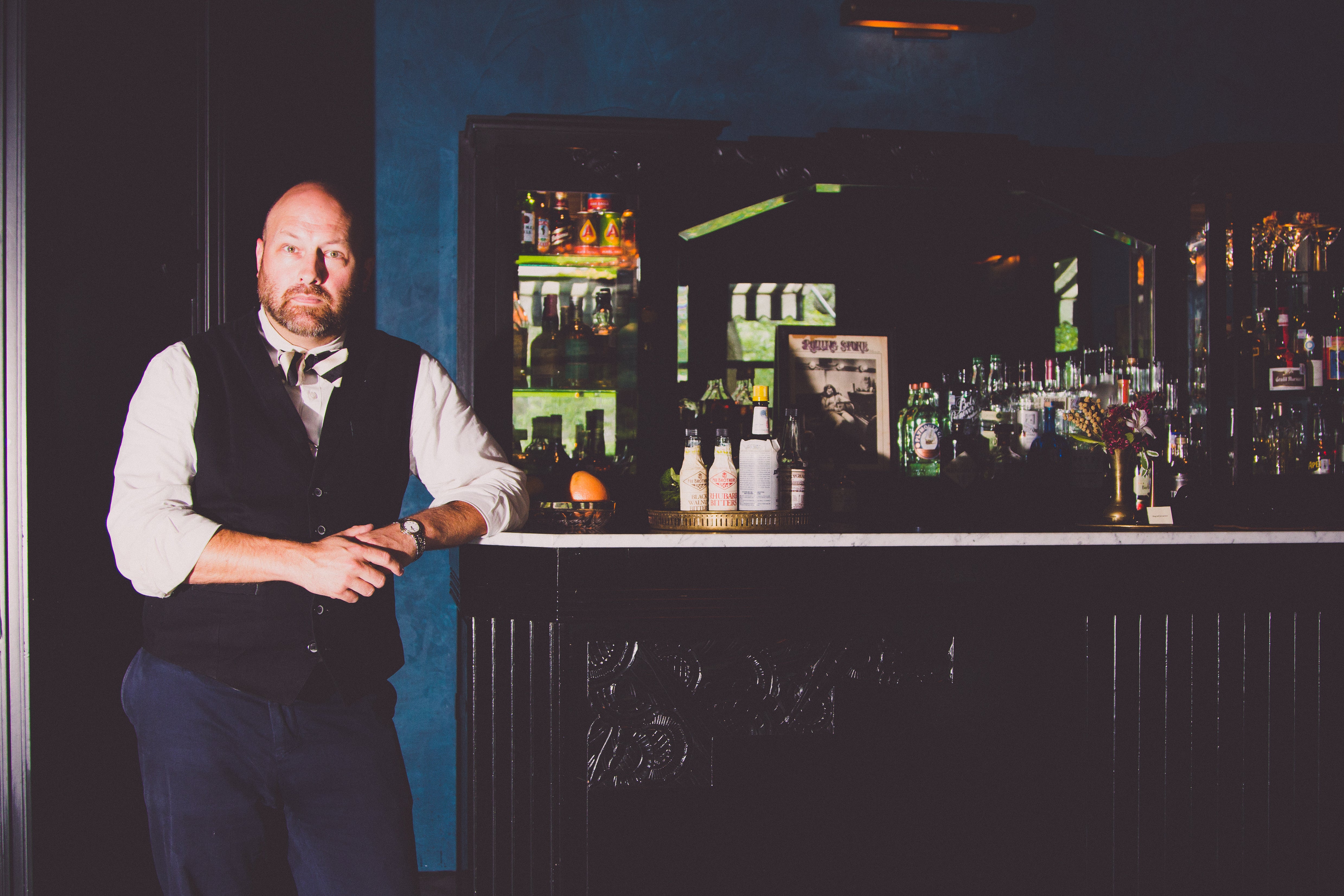 Man by a bar wearing custom Savilino uniform items