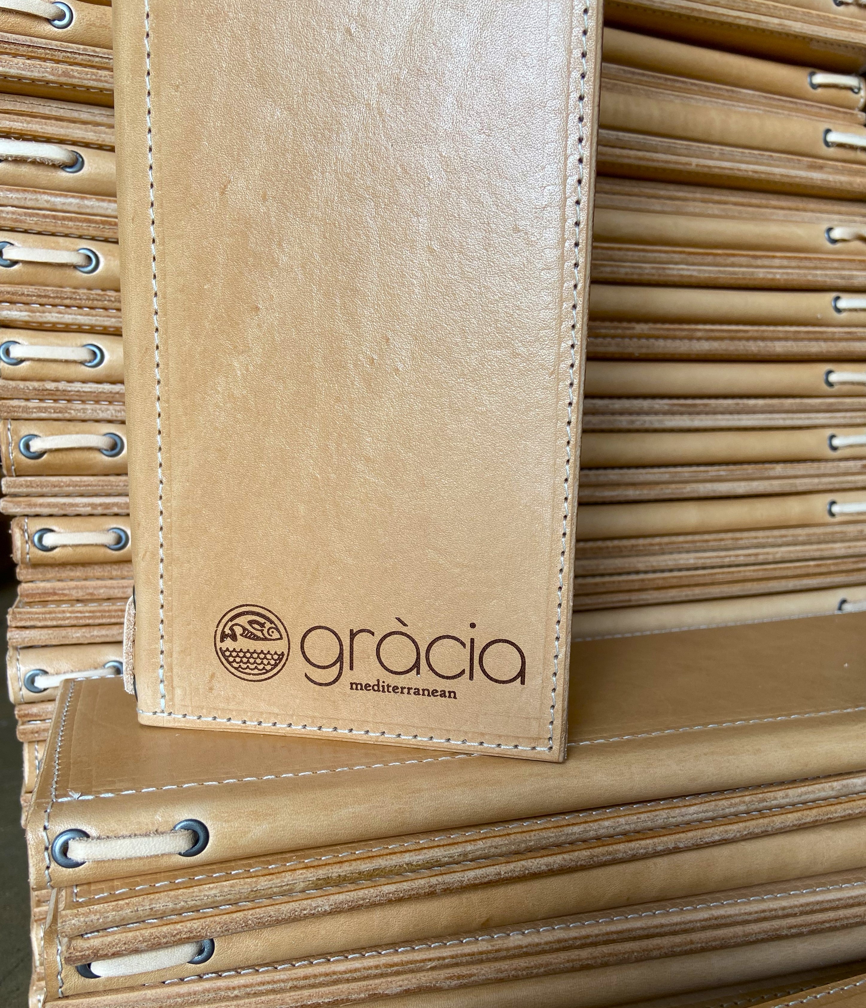 Large stack of leather menus custom made by Savilino