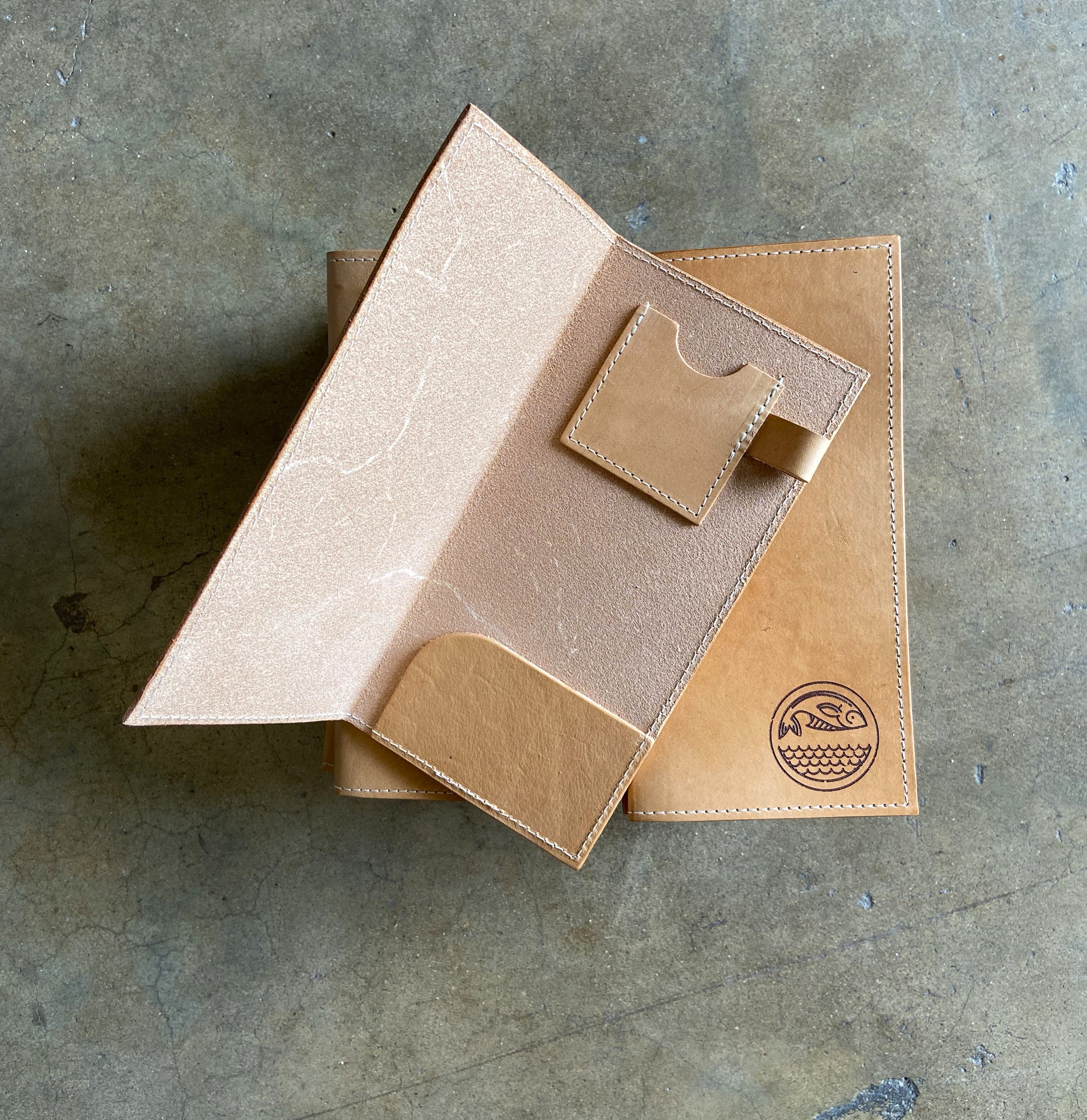 Custom veg tan leather check presenters from the Savilino studio