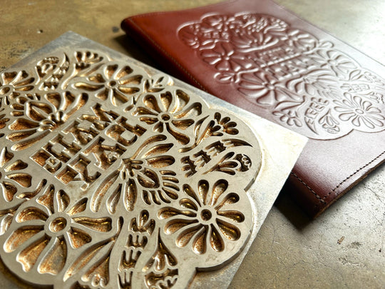 Intricate debossing stamp and Savilino custom leather debossed menu