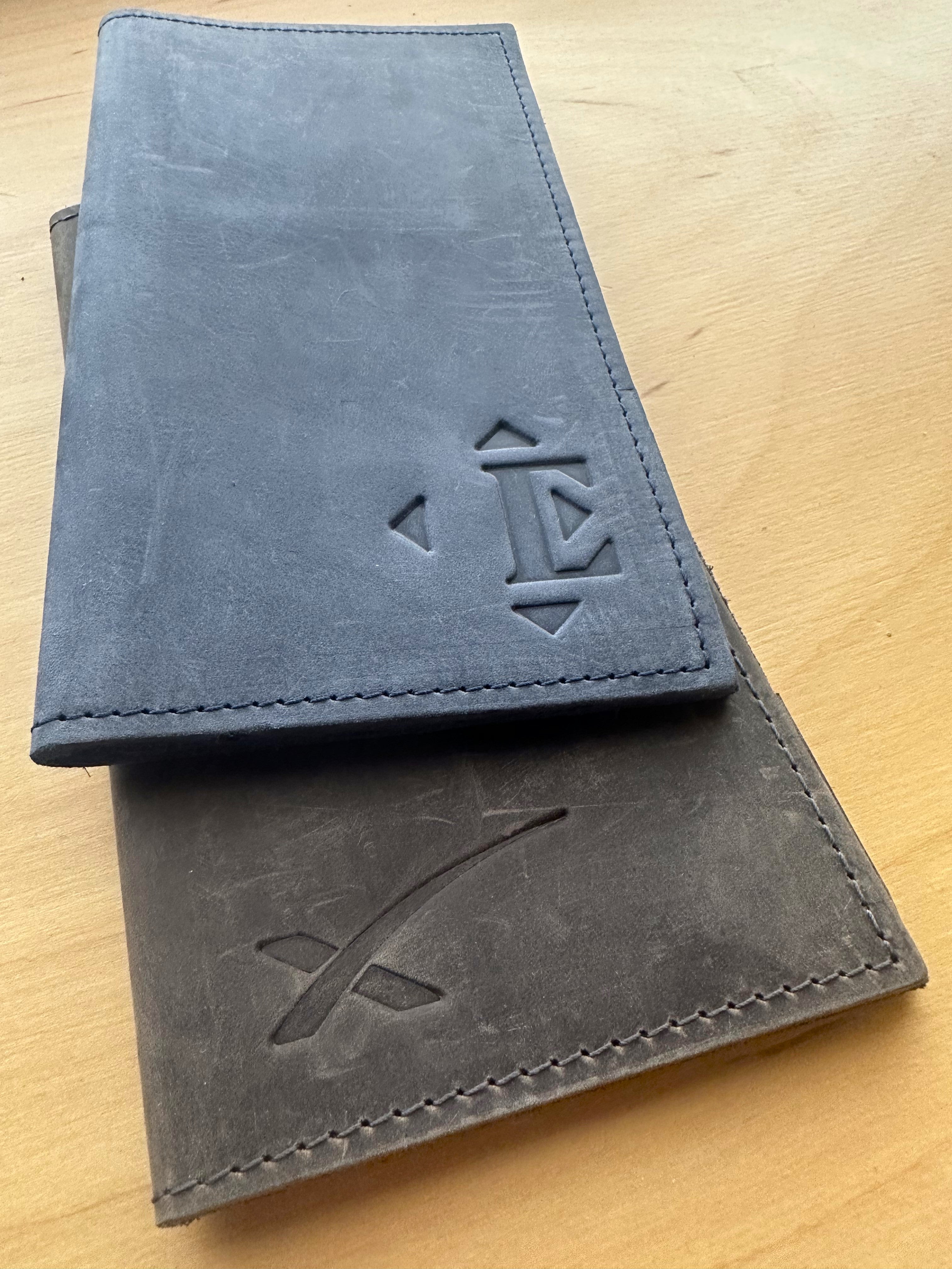 Close up of 2 leather check presenters from the Savilino studio