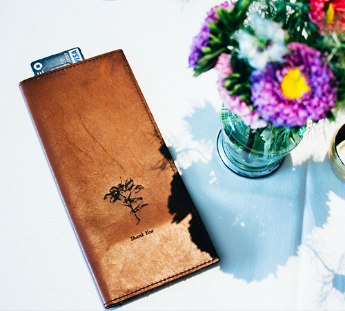 Custom leather Savilino check presenter with bright flowers