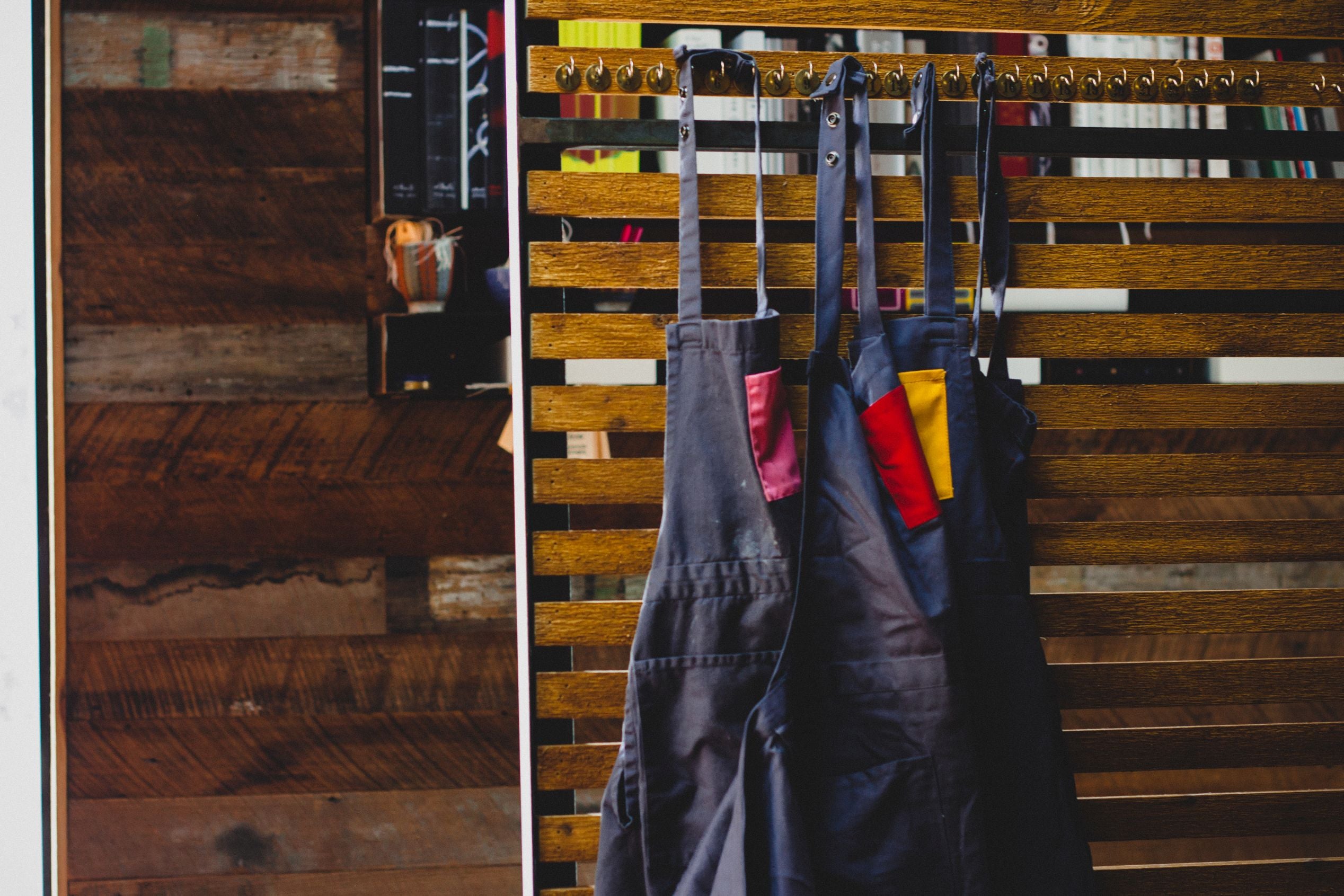 Savilino bib aprons hanging side by side