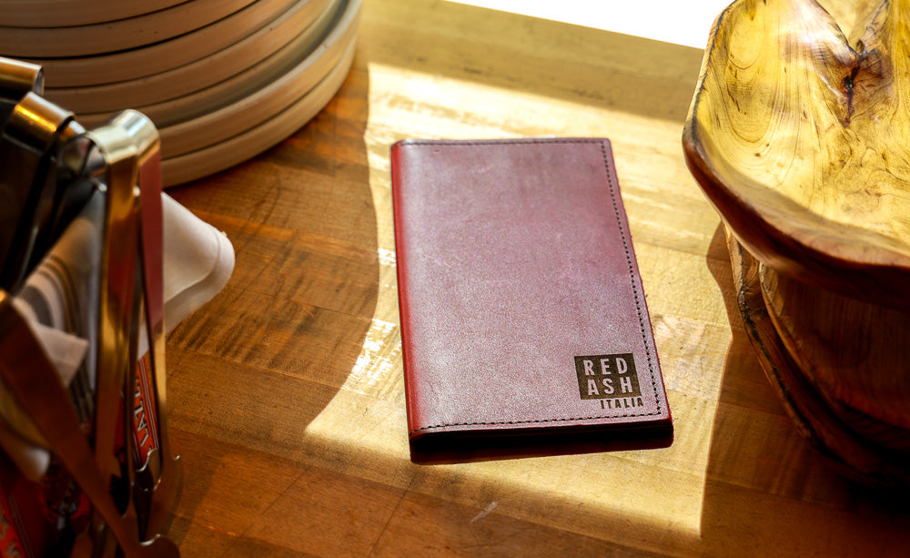 Wine colored leather check presenter made my Savilino