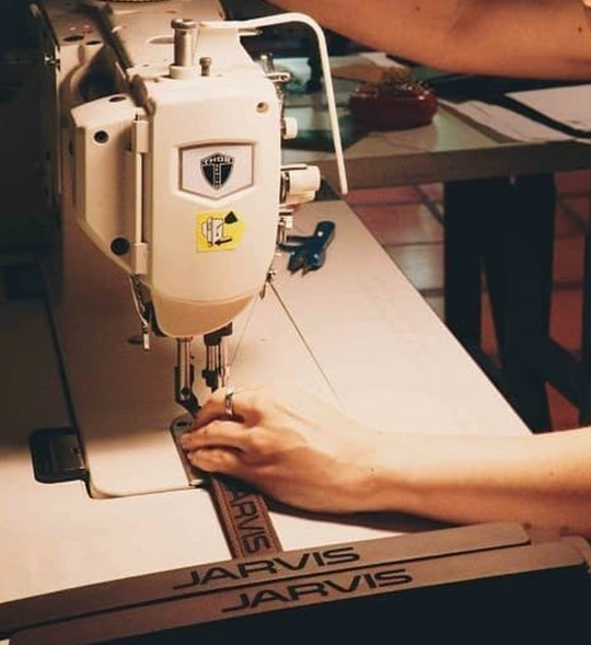 Laser cut leather being sewn in the Savilino studio