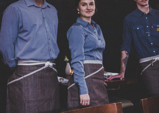 People wearing Savilino bistro aprons with secret inset pockets